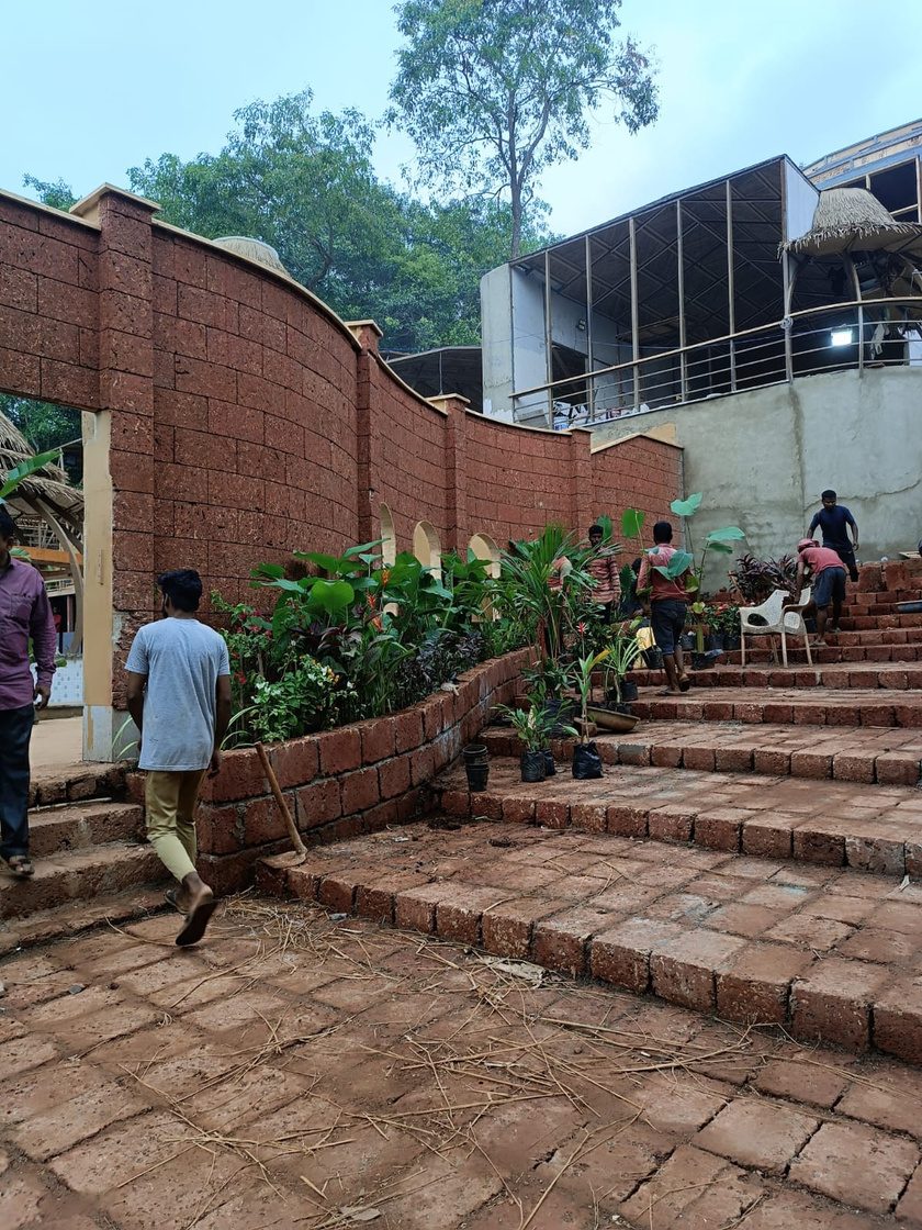 Terraced planting beds with flowering stock against a laterite wall at Diaz, Goa