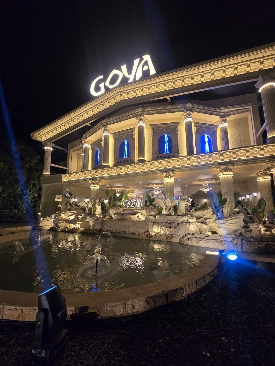 Fountain court and rock planting lit at night in front of Goya Nightclub, Vagator